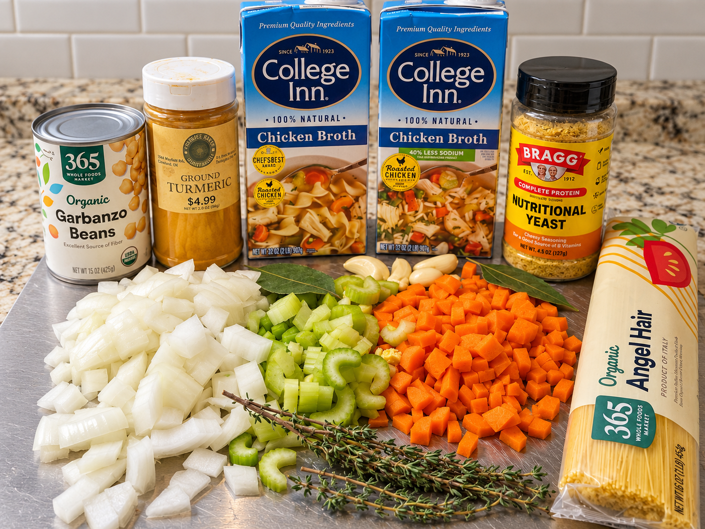 Ingredients for chickpea noodle soup including chopped vegetables, chickpeas, broth, herbs, turmeric, nutritional yeast, and angel-hair pasta