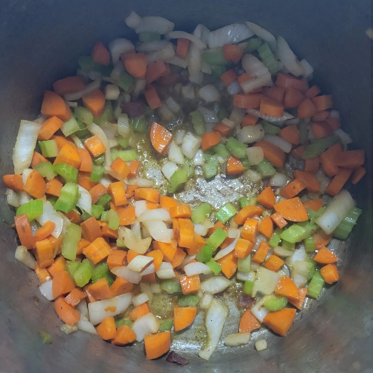 Diced onions, carrots, and celery softening in a pot