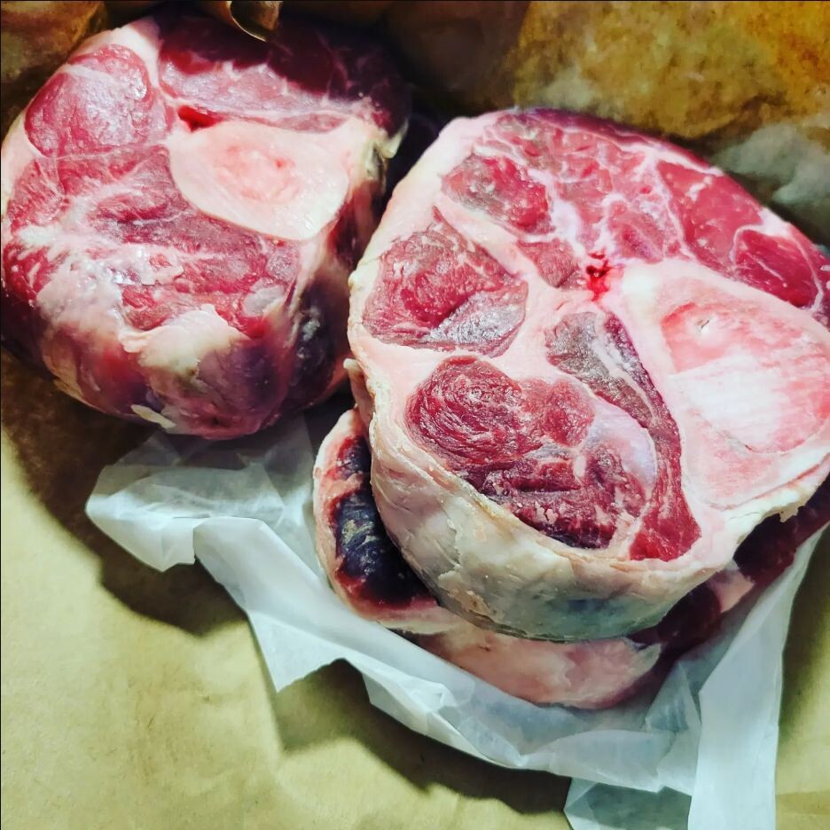 Raw cross-cut beef shanks showing the center marrow bones